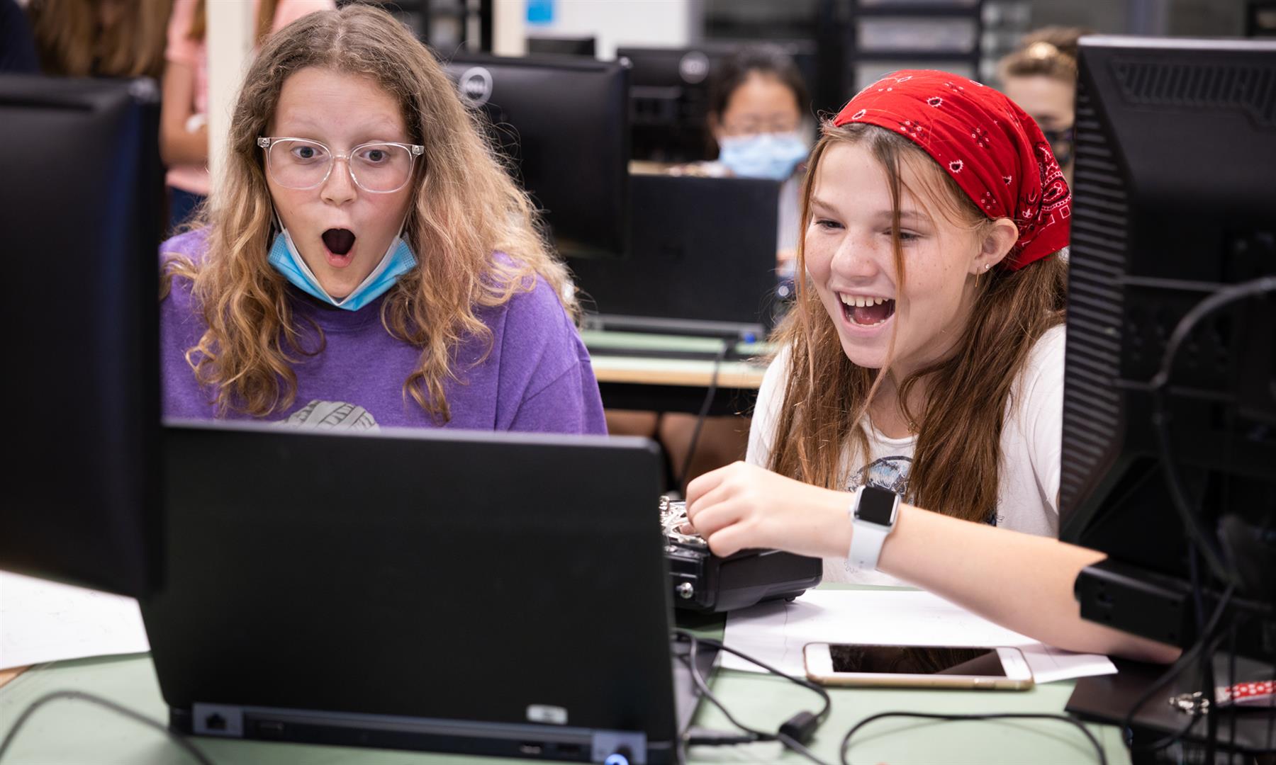Two girls use a drone simulator